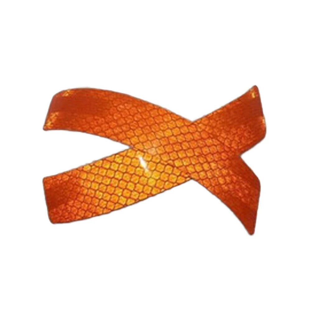 Two orange reflective fender strips or safety stickers with a textured pattern.