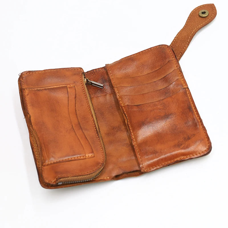 A brown vintage cowhide leather bi-fold wallet with a stitched flap and leather strap.