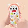 A hand holds an orange musical teether phone toy with bear ears and a keypad, demonstrating analog dialing.