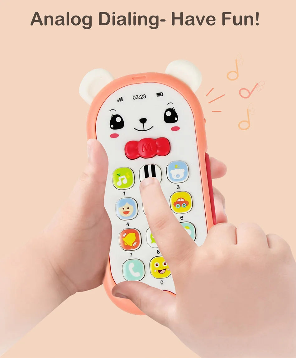 A hand holds an orange musical teether phone toy with bear ears and a keypad, demonstrating analog dialing.