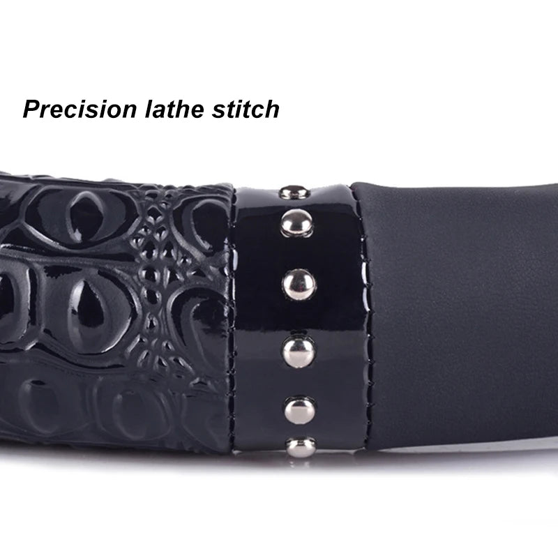 Close-up of a black crocodile grain leather steering wheel cover with precision lathe stitching.