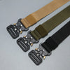 A close-up of a men's tactical nylon belt with secure metal buckles and various tan, olive green, and black webbing.