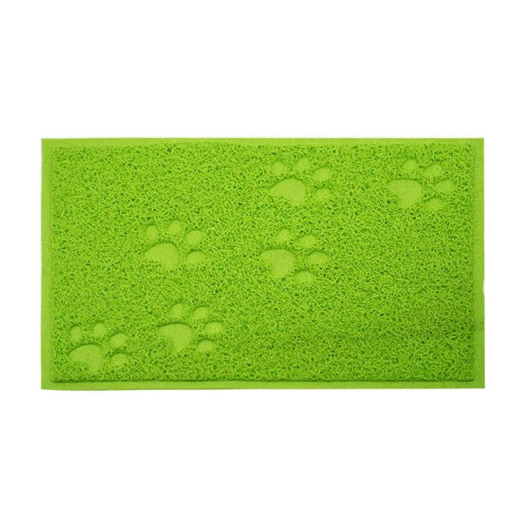 A bright lime green cat litter mat with embossed paw print designs.