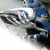 A close-up view of a chrome skull hand motorcycle side mirror.