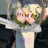 A clear balloon filled with pink flowers and text wishing a happy 40th birthday.
