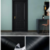 Close-up of black wood grain self-adhesive film showing texture and thickness for doors and furniture.
