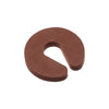 A brown foam door stopper with a curved shape designed for finger pinch protection.