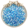 A silver-toned charm featuring a cluster of mixed blue and clear glass seed beads tied with a bow.