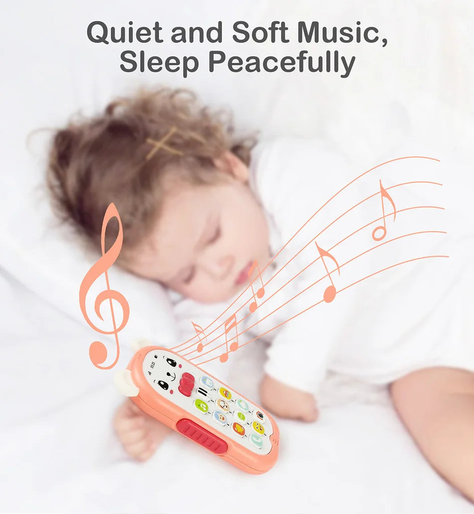 A baby is sleeping peacefully while holding an orange musical teether phone toy with lights and sounds.