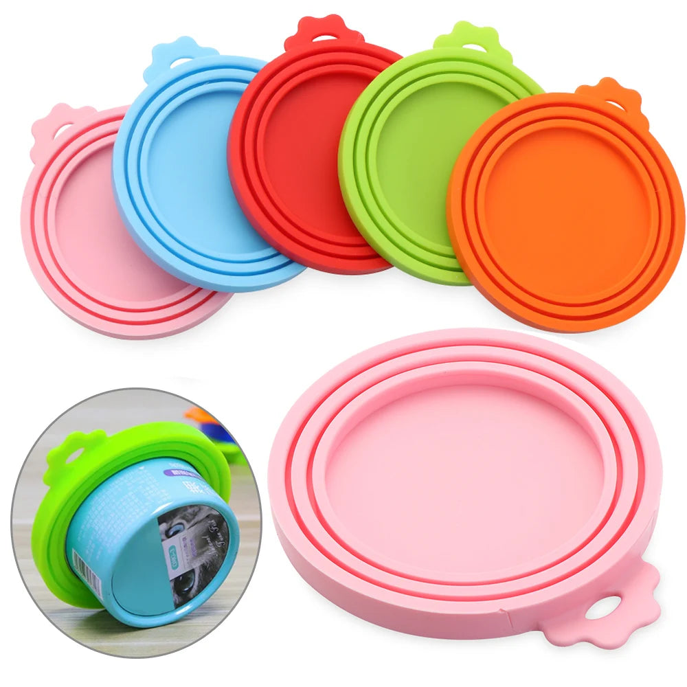 A set of three colorful reusable silicone food storage lids in pink, blue, and orange are displayed, with one lid shown on a 