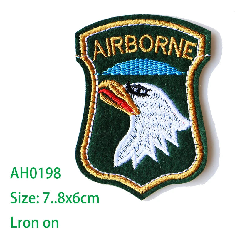 Embroidered Airborne patch featuring a white eagle head on a green background with gold stitching.