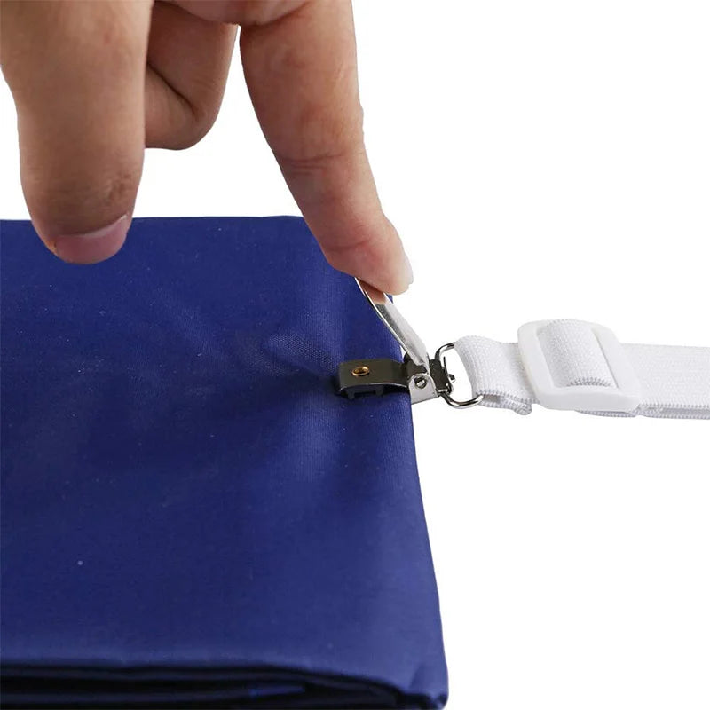 A hand is using a metal clip to open a blue fabric pouch with a white adjustable strap.