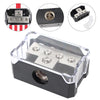 A clear plastic power distribution block for car audio, featuring four terminals and a fuse holder.