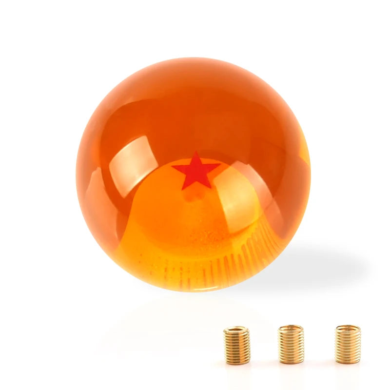 A glossy orange shift knob with a red star design shown against a white background.