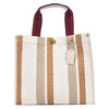 A beige and white striped canvas tote bag with brown straps.