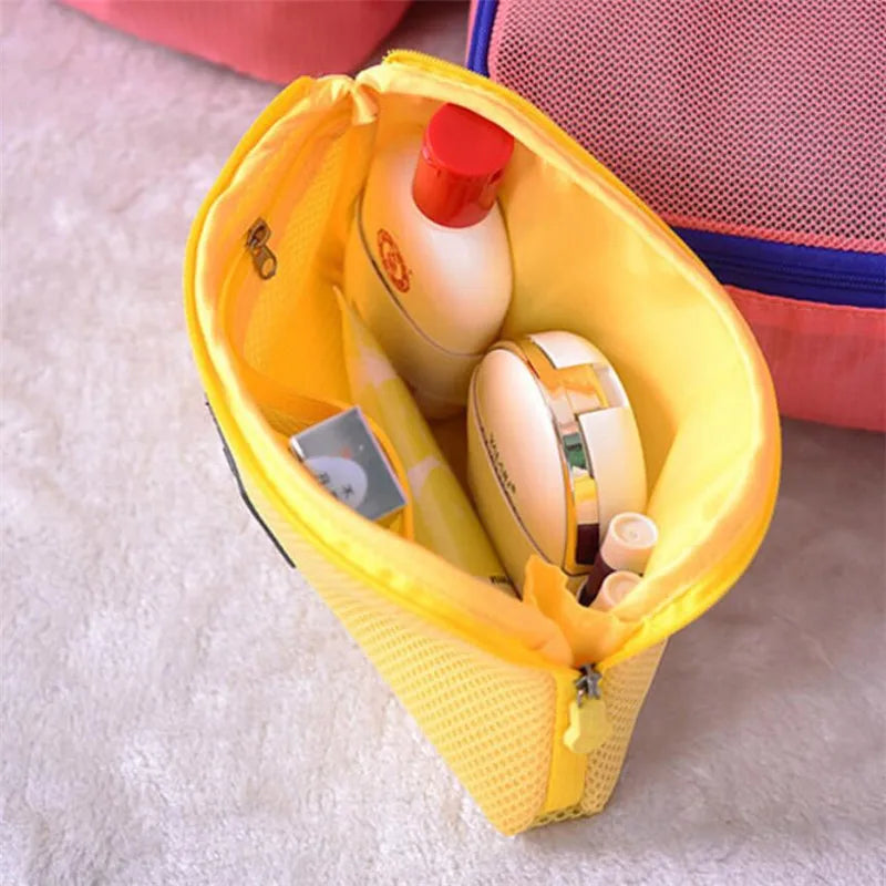 A yellow compact travel cable organizer bag is open, showing a bottle and a watch inside.