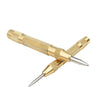 A gold-colored spring-loaded automatic center punch tool with a sharp point.