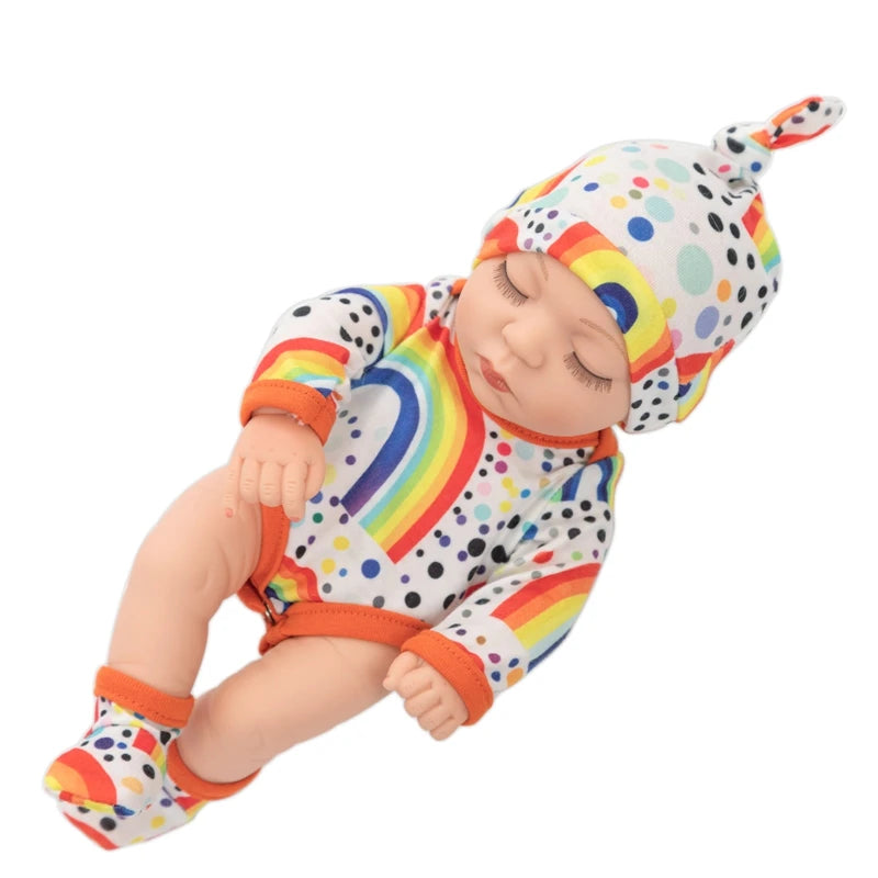 A baby doll wearing a colorful striped jumpsuit and matching hat.