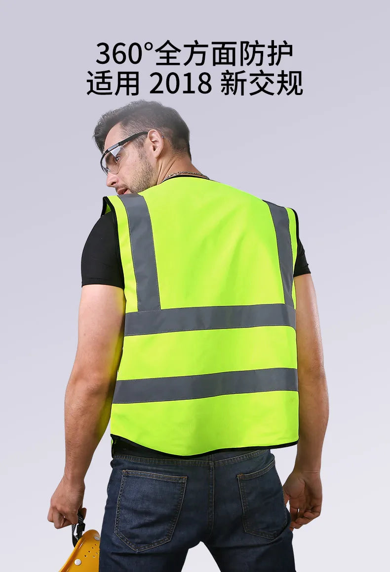 A man wearing a bright yellow high-visibility safety vest with reflective stripes, shown from the back.