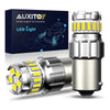 A pair of silver LED car bulbs with yellow light elements are shown next to their packaging box.