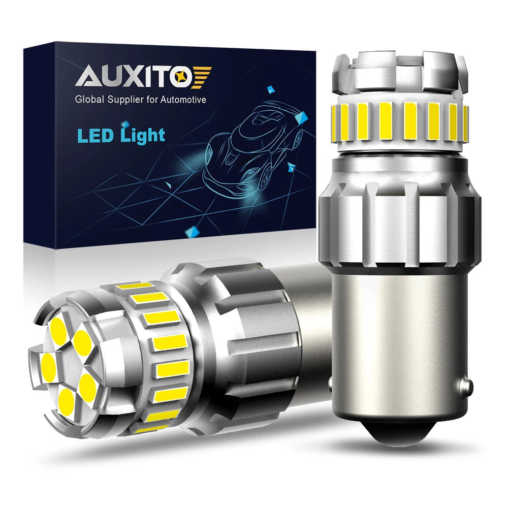 A pair of silver LED car bulbs with yellow light elements are shown next to their packaging box.