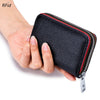 A hand holds a black leather card holder with a zipper and RFID protection feature.