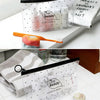 A clear transparent travel toiletry bag with a hanging hook filled with various beauty products.