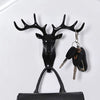 Black vintage deer head wall hook featuring antlers used for hanging hats, scarves, and keys.