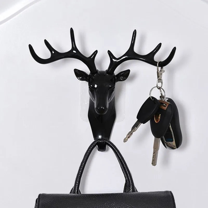 Black vintage deer head wall hook featuring antlers used for hanging hats, scarves, and keys.