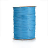 A spool of bright blue waxed cotton cord used for jewelry making.