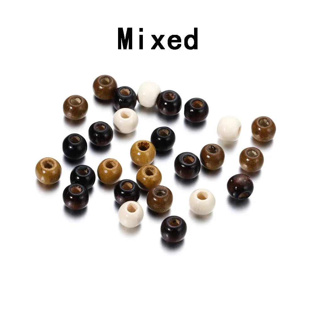 A collection of mixed natural wooden and white spacer beads scattered on a white background.