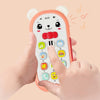 A hand is holding an orange musical teether phone toy with a bear face and colorful buttons.