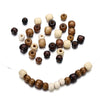 A collection of natural wooden spacer beads in various shades and sizes scattered on a white background.