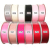 A collection of double face satin ribbon rolls in various solid colors and numbers, including pink, beige, black, and red.
