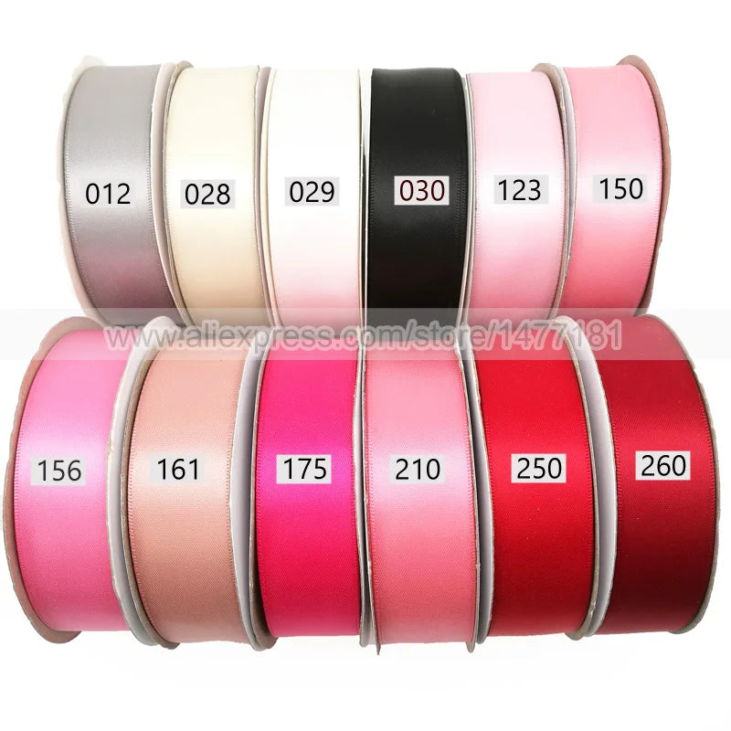 A collection of double face satin ribbon rolls in various solid colors and numbers, including pink, beige, black, and red.