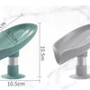 A leaf-shaped suction cup soap dish with a self-draining tray shown in teal and gray colors.