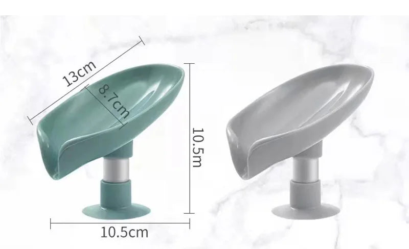 A leaf-shaped suction cup soap dish with a self-draining tray shown in teal and gray colors.