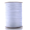 A spool of white waxed cotton cord used for jewelry making