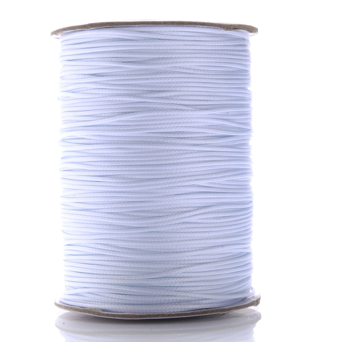 A spool of white waxed cotton cord used for jewelry making