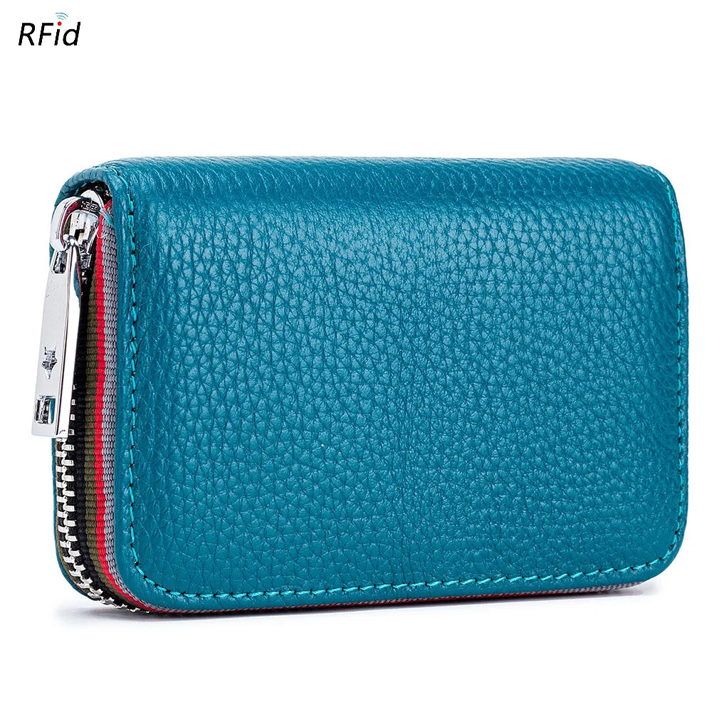 A teal leather card holder with a zipper closure and RFID protection features a textured surface.