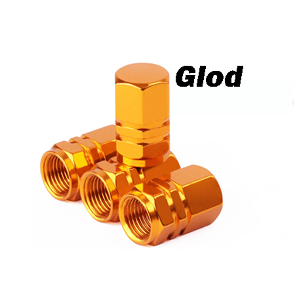 A stack of brass-colored tire valve caps, labeled Glod, showing various sizes and designs.