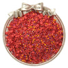 A silver dish filled with a mix of red and orange glass seed beads for jewelry making