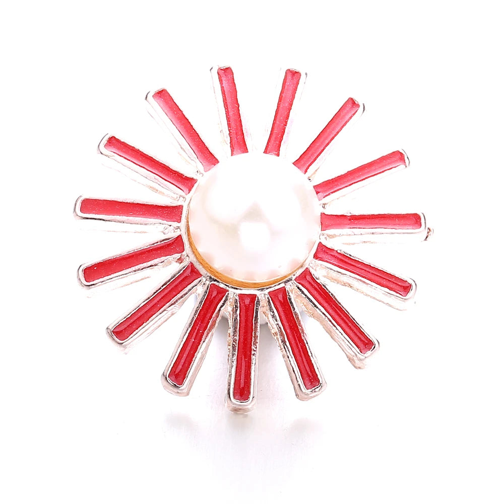 A sunburst design of red metal snap buttons with a central pearl, used for jewelry making.