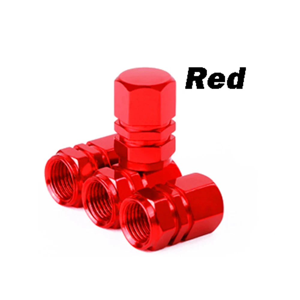 A stack of red durable aluminum tire valve caps.
