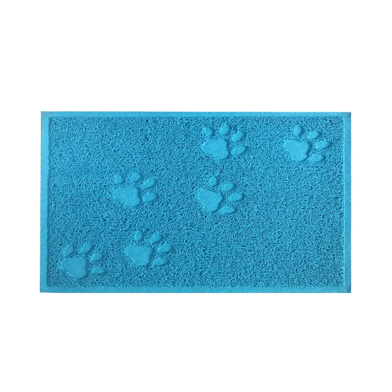 A teal silicone cat litter mat with multiple paw print designs for non-slip use.