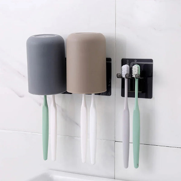Wall-mounted toothbrush and cup holder with a gray and beige brush and cup.