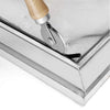 A close-up view of a DIY insect screen mesh kit with a silver rolling tool and wooden handle resting on a metal frame.