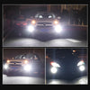 Two pairs of ultra-bright LED fog light bulbs illuminating a vehicle at night.