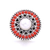 Round silver metal snap buttons with red beads surrounding a central white pearl for jewelry making