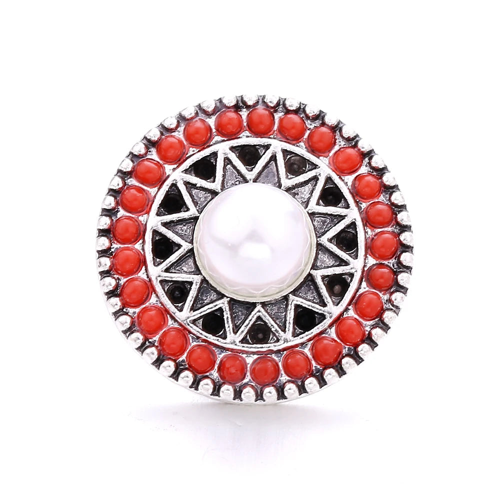 Round silver metal snap buttons with red beads surrounding a central white pearl for jewelry making